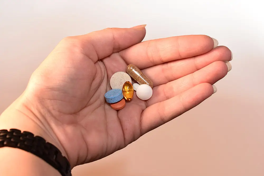 hormonal contraception: pills of different colors are in hand