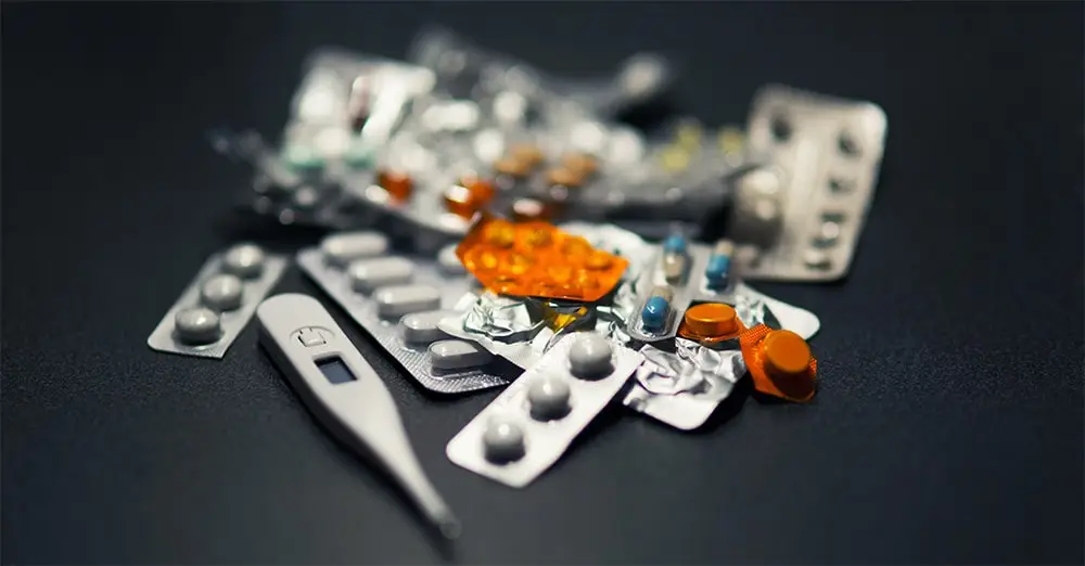 mononucleosis: pills on a black table