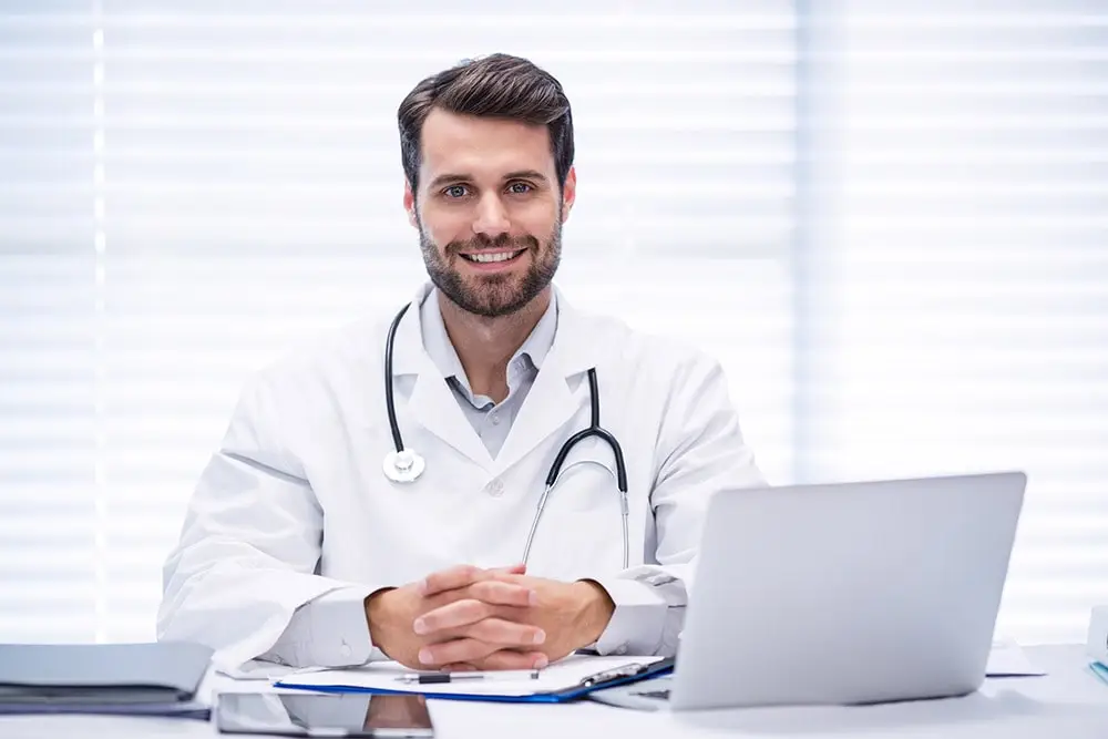 allergist doctor sitting in front of the computer