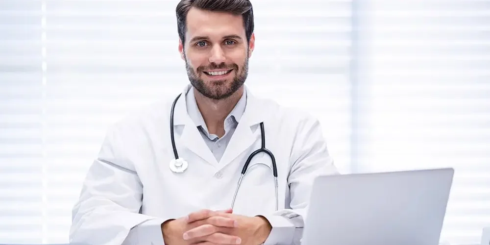 allergist doctor sitting in front of the computer